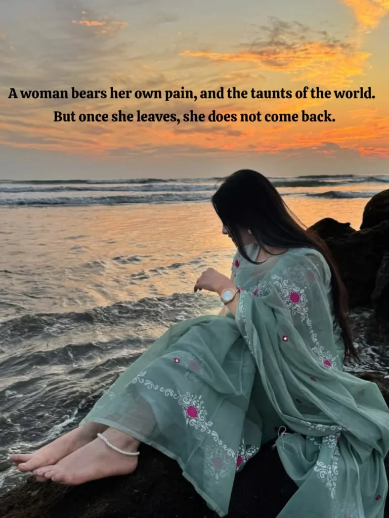woman in green dress sitting on rocks at sunset showing pain of a woman's loyalty