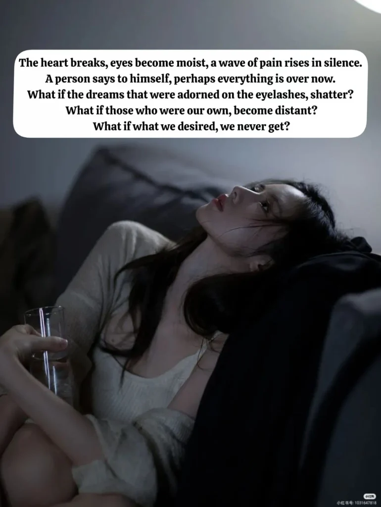 sorrowful woman lying on a sofa holding a glass of water, lost in heartbreak thoughts